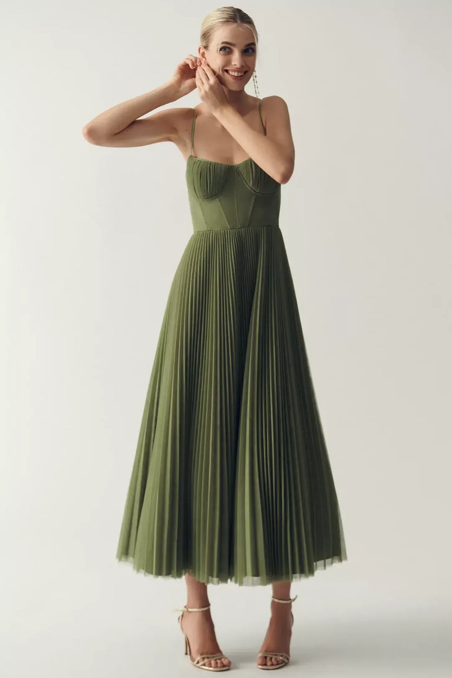 Woman wearing a green sweetheart corset midi dress
