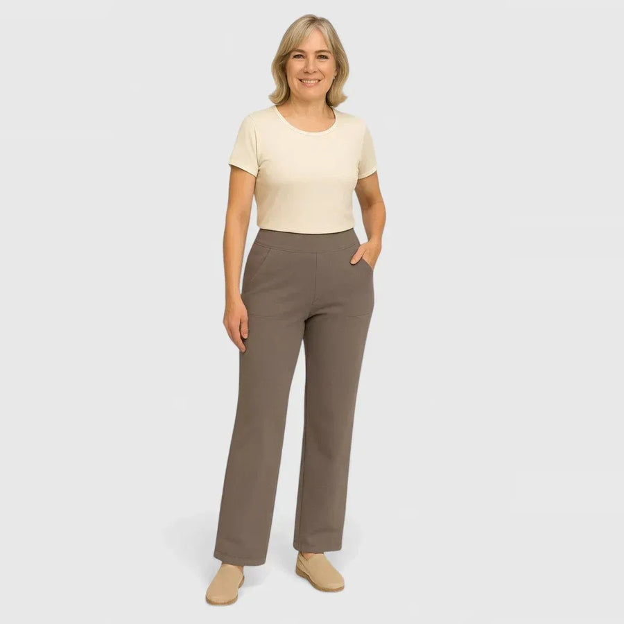 Woman wearing taupe straight-leg trousers with a cream top