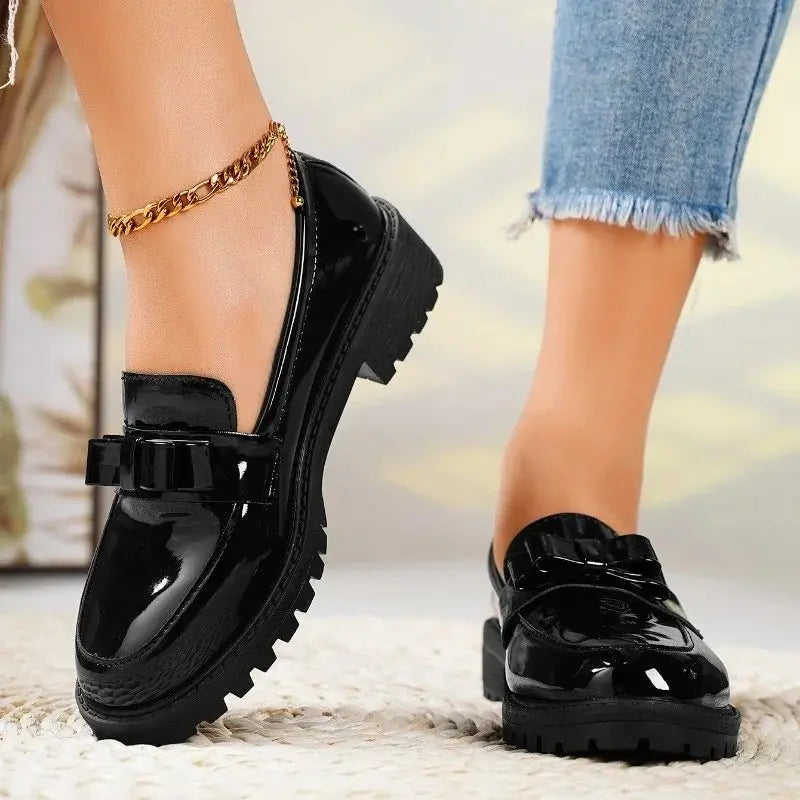 Patent bow loafers in Black, three-quarter view